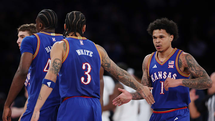 Kansas basketball players Tre White (3) and Jayden Dawson (1)