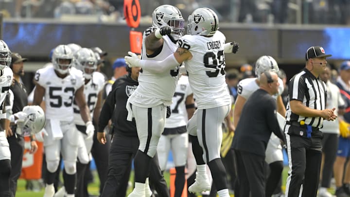 Sep 8, 2024; Inglewood, California, USA; Las Vegas Raiders defensive tackle Nesta Jade Silvera (99) celebrates with defensive end Maxx Crosby (98) a sack of Los Angeles Chargers quarterback Justin Herbert (10) in the first half at SoFi Stadium. Mandatory Credit: Jayne Kamin-Oncea-Imagn Images