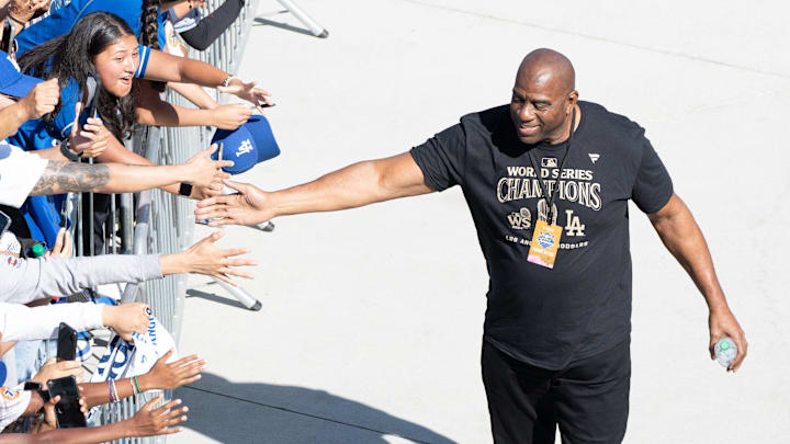 Los Angeles Dodgers minority owner and former Los Angeles Laker Magic Johnson celebrates World Series win.