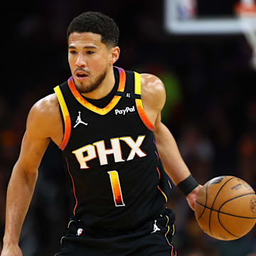 Phoenix Suns guard Devin Booker dribbles the ball against the Oklahoma City Thunder.