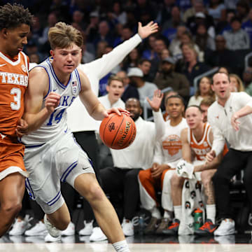 Nov 4, 2025; Charlotte, North Carolina, USA; Duke Blue Devils guard Nikolas Khamenia (14) dribbles the ball with Texas Longhorns forward Dailyn Swain (3) defending during the first quarter at the Dick Vitale’s Invitational game at Spectrum Center. Mandatory Credit: Cory Knowlton-Imagn Images