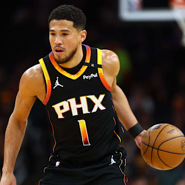 Apr 9, 2025; Phoenix, Arizona, USA; Phoenix Suns guard Devin Booker (1) dribbles the ball against the Oklahoma City Thunder during the first half at Footprint Center. Mandatory Credit: Mark J. Rebilas-Imagn Images