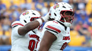 Sep 27, 2025; Pittsburgh, Pennsylvania, USA;  Louisville Cardinals defensive lineman Rene Konga (90) celebrates his sack with defensive lineman Jerry Lawson (left) against the Pittsburgh Panthers during the fourth quarter at Acrisure Stadium. Mandatory Credit: Charles LeClaire-Imagn Images