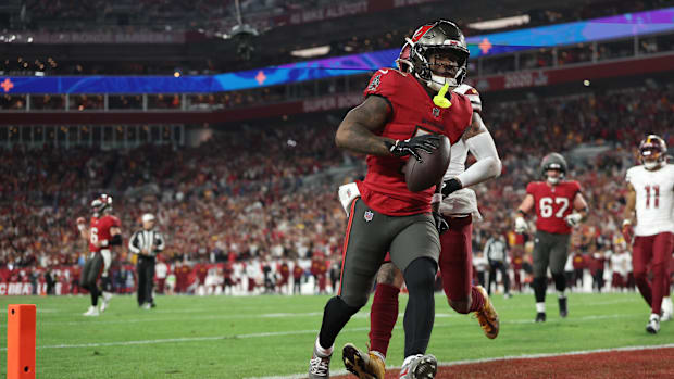 Jan 12, 2025; Tampa, Florida, USA; Tampa Bay Buccaneers running back Bucky Irving (7) makes a touchdown catch against Washing