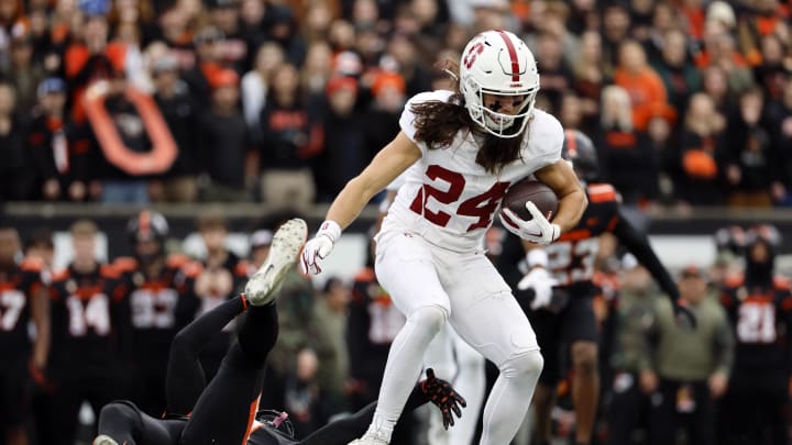 Nov 11, 2023; Corvallis, Oregon, USA; Stanford Cardinal wide receiver Tiger Bachmeier (24) is grabbed by Oregon State Beavers defensive back Akili Arnold (0) during the first half at Reser Stadium. Mandatory Credit: Soobum Im-USA TODAY Sports