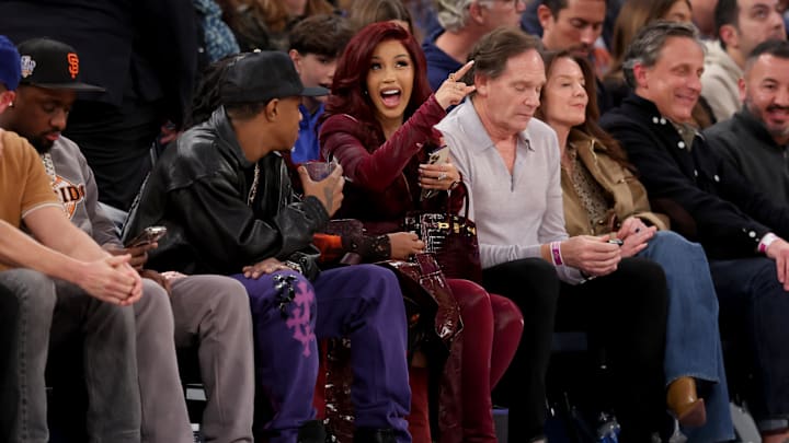 Nov 8, 2024; New York, New York, USA; American rapper Cardi B (center) talks to rapper A Boogie Wit da Hoodie (left) during the third quarter between the New York Knicks and the Milwaukee Bucks at Madison Square Garden. Mandatory Credit: Brad Penner-Imagn Images