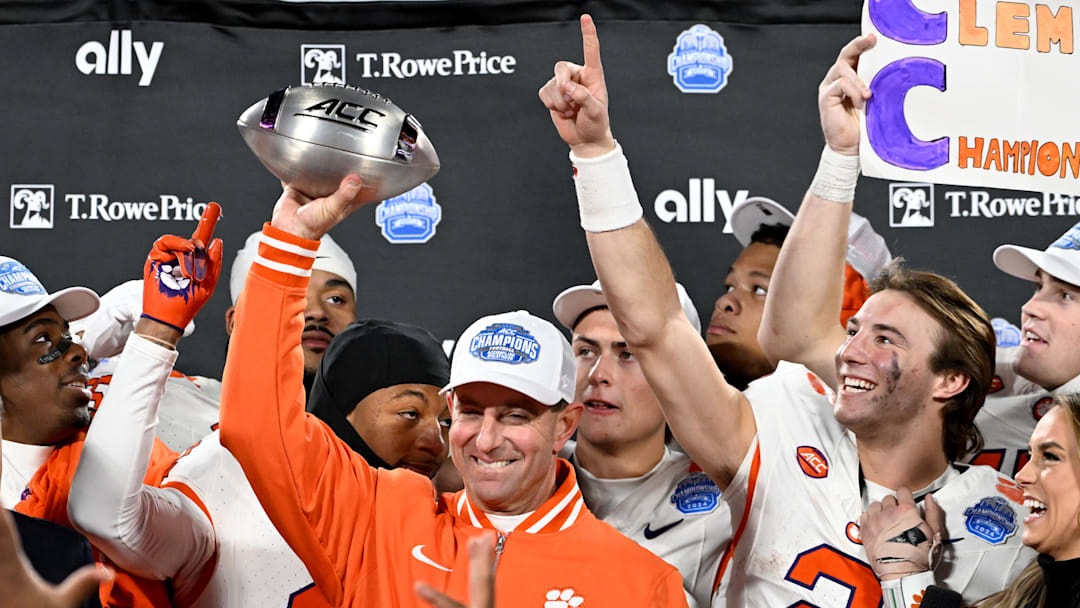 Dec 7, 2024; Charlotte, NC, USA; Clemson Tigers head coach Dabo Swinney, quarterback Cade Klubnik (2) and teammates celebrate after winning the 2024 ACC Championship game against the Southern Methodist Mustangs at Bank of America Stadium. Mandatory Credit: Bob Donnan-Imagn Images
