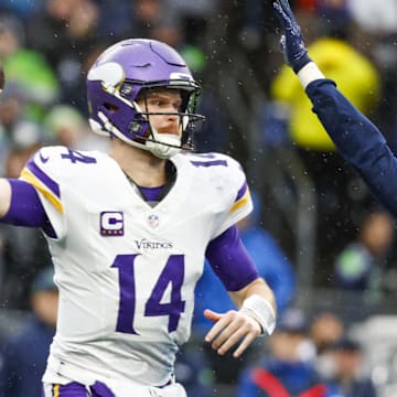 Dec 22, 2024; Seattle, Washington, USA; Minnesota Vikings quarterback Sam Darnold (14) passes against the Seattle Seahawks during the second quarter at Lumen Field.