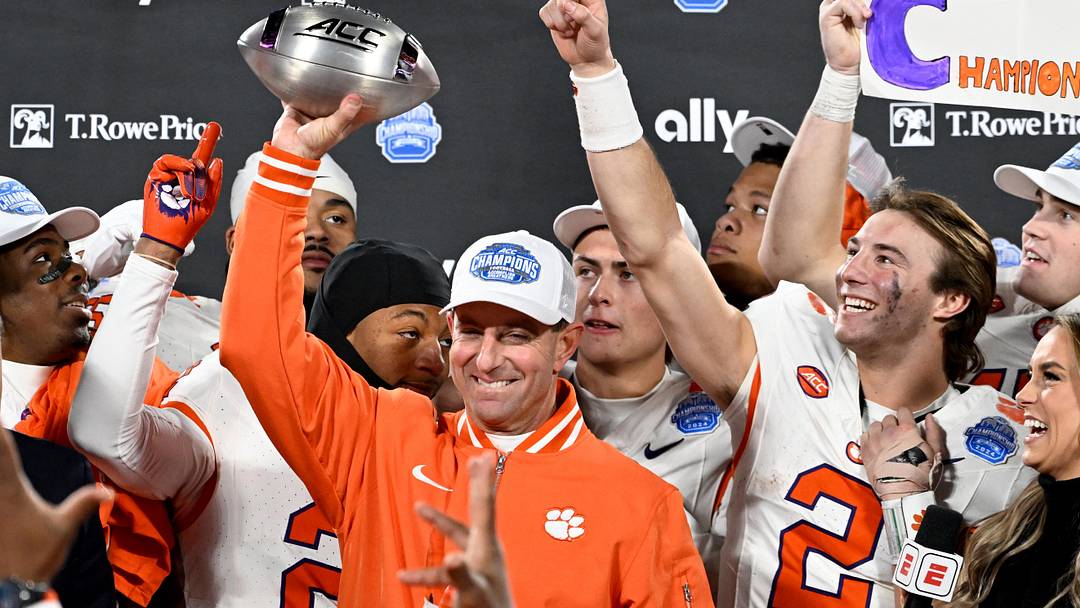 Dec 7, 2024; Charlotte, NC, USA; Clemson Tigers head coach Dabo Swinney, quarterback Cade Klubnik (2) and teammates celebrate after winning the 2024 ACC Championship game against the Southern Methodist Mustangs at Bank of America Stadium. Mandatory Credit: Bob Donnan-Imagn Images
