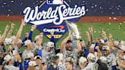 Nov 1, 2025; Toronto, Ontario, CAN; Los Angeles Dodgers pitcher Clayton Kershaw (22) celebrates with the Commissioner's Trophy after defeating the Toronto Blue Jays in game seven of the 2025 MLB World Series at Rogers Centre. Mandatory Credit: Kevin Sousa-Imagn Images