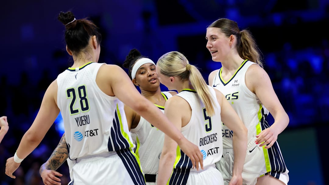Jul 3, 2025; Arlington, Texas, USA;  Dallas Wings guard Paige Bueckers (5) celebrates with Dallas Wings center Luisa Geiselsoder (18) and Dallas Wings center Li Yueru (28) and Dallas Wings guard Aziaha James (10) against the Phoenix Mercury during the first half at College Park Center. Mandatory Credit: Kevin Jairaj-Imagn Images