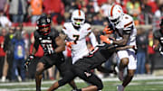 Oct 19, 2024; Louisville, Kentucky, USA;   Miami Hurricanes running back Mark Fletcher Jr. (4) runs the ball against Louisville Cardinals defensive back Tamarion McDonald (12) during the first half at L&N Federal Credit Union Stadium. Miami defeated Louisville 52-45. Mandatory Credit: Jamie Rhodes-Imagn Images