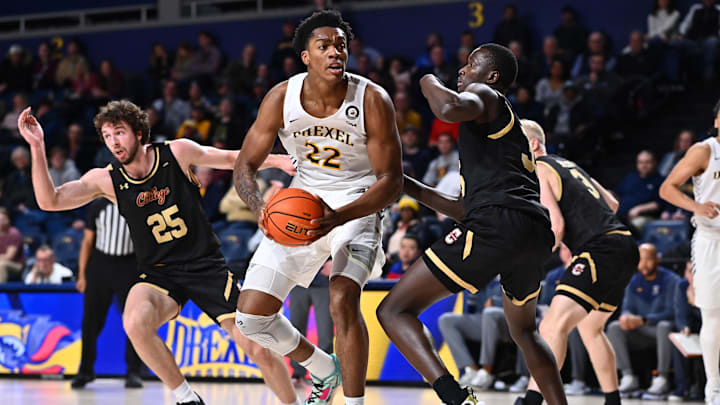 Feb 2, 2023; Philadelphia, Pennsylvania, USA; Drexel Dragons forward Amari Williams (22) drives against Charleston Cougars forward Babacar Faye (35) in the second half at Daskalakis Athletic Center. Mandatory Credit: Kyle Ross-Imagn Images