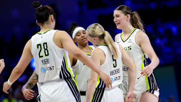 Jul 3, 2025; Arlington, Texas, USA;  Dallas Wings guard Paige Bueckers (5) celebrates with Dallas Wings center Luisa Geiselsoder (18) and Dallas Wings center Li Yueru (28) and Dallas Wings guard Aziaha James (10) against the Phoenix Mercury during the first half at College Park Center. Mandatory Credit: Kevin Jairaj-Imagn Images