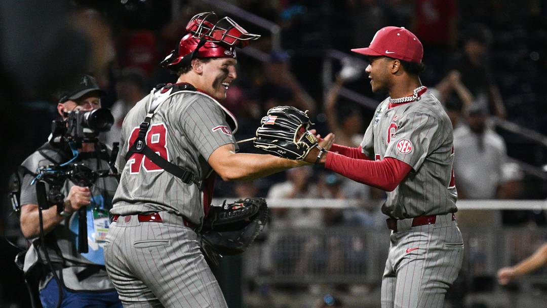 Jun 17, 2026; Omaha, NE, USA;  Oklahoma Sooners pitcher LJ Mercurius (22) and catcher Deiten Lachance (48) celebrate the win against the Georgia Bulldogs at Charles Schwab Field. Mandatory Credit: Steven Branscombe-Imagn Images