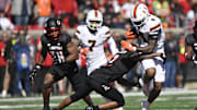 Oct 19, 2024; Louisville, Kentucky, USA;   Miami Hurricanes running back Mark Fletcher Jr. (4) runs the ball against Louisville Cardinals defensive back Tamarion McDonald (12) during the first half at L&N Federal Credit Union Stadium. Miami defeated Louisville 52-45. Mandatory Credit: Jamie Rhodes-Imagn Images
