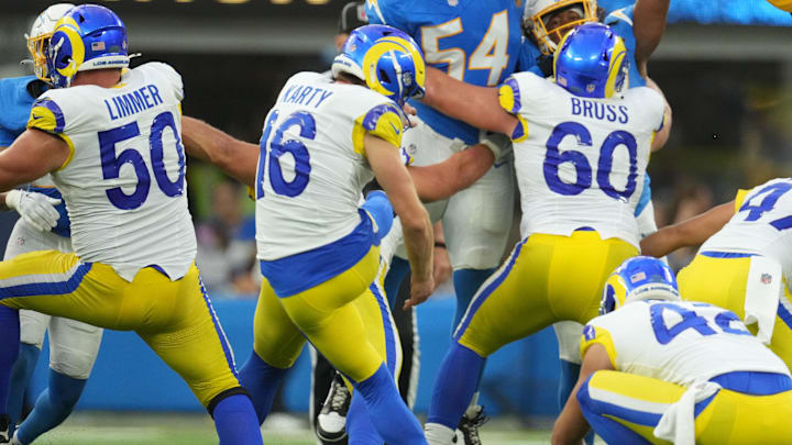 Aug 17, 2024; Inglewood, California, USA; Los Angeles Rams place kicker Joshua Karty (16) attempts a field goal against Los Angeles Chargers linebacker Savion Jackson (54) in the second half at SoFi Stadium. Mandatory Credit: Kirby Lee-Imagn Images