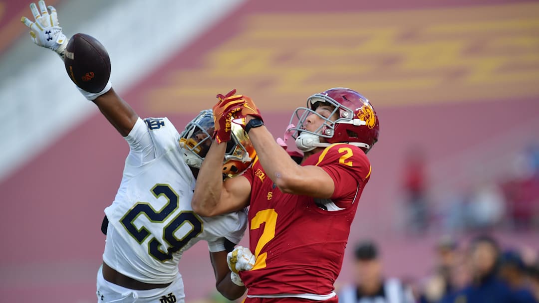 Nov 30, 2024; Los Angeles, California, USA; Notre Dame Fighting Irish cornerback Christian Gray (29) blocks a pass intended for Southern California Trojans wide receiver Duce Robinson (2) during the second half at the Los Angeles Memorial Coliseum. Mandatory Credit: Gary A. Vasquez-Imagn Images