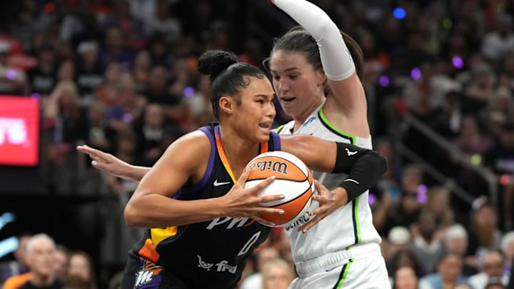 Sep 28, 2025; Phoenix, Arizona, USA; Phoenix Mercury forward Satou Sabally (0) drives on Minnesota Lynx forward Bridget Carleton (6) in the first half during game four of the second round for the 2025 WNBA Playoffs at PHX Arena. Mandatory Credit: Rick Scuteri-Imagn Images