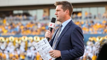 Oct 5, 2019; Morgantown, WV, USA; ESPN broadcaster Todd McShay talks along the sidelines during the third quarter at Mountaineer Field at Milan Puskar Stadium. Mandatory Credit: Ben Queen-Imagn Images
