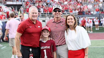 Aug 29, 2024; Little Rock, Arkansas, USA; Arkansas Razorbacks athletic director Hunter Yurachek poses for a photo with Arkansas governor Sarah Huckabee Sanders and her family prior to the game against the Pine Bluff Golden Lions at War Memorial Stadium. Mandatory Credit: Nelson Chenault-Imagn Images