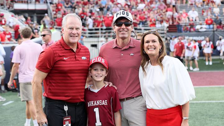 Aug 29, 2024; Little Rock, Arkansas, USA; Arkansas Razorbacks athletic director Hunter Yurachek poses for a photo with Arkansas governor Sarah Huckabee Sanders and her family prior to the game against the Pine Bluff Golden Lions at War Memorial Stadium. Mandatory Credit: Nelson Chenault-Imagn Images