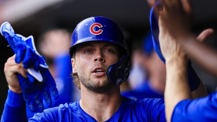 Jul 31, 2024; Cincinnati, Ohio, USA; Chicago Cubs second baseman Nico Hoerner (2) high fives teammates after scoring on a RBI single hit by catcher Christian Bethancourt (not pictured) in the second inning against the Cincinnati Reds at Great American Ball Park