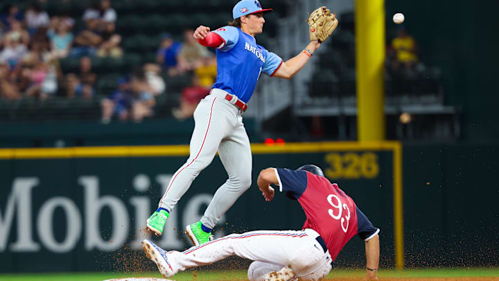 American League outfielder Spencer Jones steals second base ahead of the tag by National League infielder Aidan Miller. American League outfielder Spencer Jones steals second base ahead of the tag by National League infielder Aidan Miller.