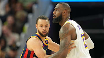 Jan 25, 2025; San Francisco, California, USA; Golden State Warriors guard Stephen Curry (left) defends against Los Angeles Lakers forward LeBron James (right) during the fourth quarter at Chase Center. Mandatory Credit: Darren Yamashita-Imagn Images