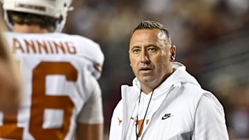 Nov 30, 2024; College Station, Texas, USA; Texas Longhorns head coach Steve Sarkisian speaks with quarterback Arch Manning (16) during warm ups against the Texas A&M Aggies at Kyle Field. 