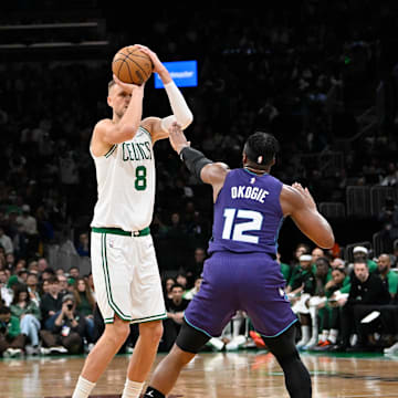 Apr 11, 2025; Boston, Massachusetts, USA; Boston Celtics center Kristaps Porzingis (8) shoots over Charlotte Hornets forward Josh Okogie (12) during the first half at TD Garden. Mandatory Credit: Eric Canha-Imagn Images