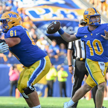 Sep 14, 2024; Pittsburgh, Pennsylvania, USA; Pittsburgh Panthers quarterback Eli Holstein (10) throws a touchdown pass against the West Virginia Mountaineers during the second quarter at Acrisure Stadium. Mandatory Credit: Barry Reeger-Imagn Images