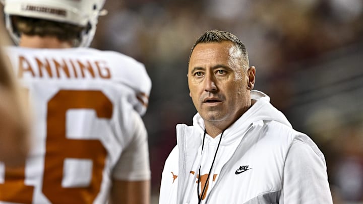 Nov 30, 2024; College Station, Texas, USA; Texas Longhorns head coach Steve Sarkisian speaks with quarterback Arch Manning (16) during warm ups against the Texas A&M Aggies at Kyle Field. Mandatory Credit: Maria Lysaker-Imagn Images 