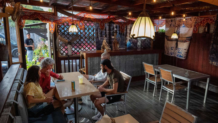 Diners sit in the patio at King Tut's in Nashville, Tenn., Thursday, Aug. 22, 2024.