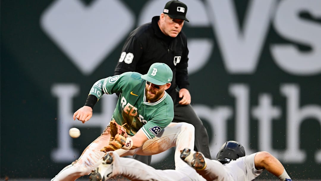 Trevor Story applies the tag to Jasson Domínguez in a New York Yankees v Boston Red Sox game.