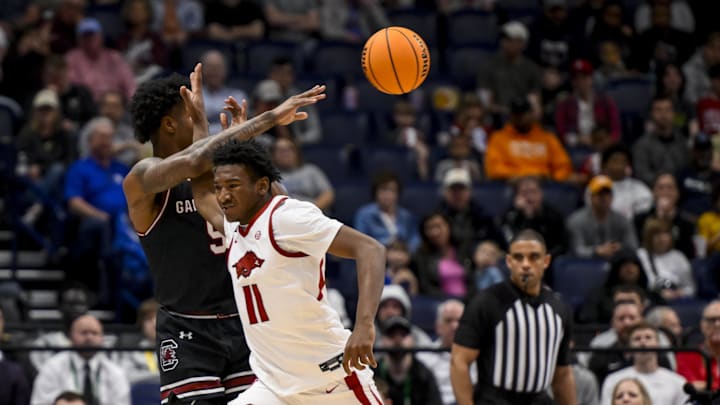 Mar 12, 2025; Nashville, TN, USA;  Arkansas Razorbacks forward Karter Knox (11) blocks the pass from South Carolina Gamecocks forward Nick Pringle (5) during the second half at Bridgestone Arena. Mandatory Credit: Steve Roberts-Imagn Images