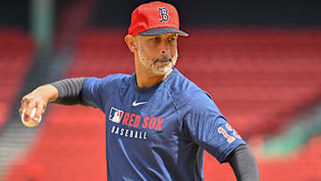 Boston Red Sox manager Alex Cora (13) pitches balls during batting practice before a game against the Toronto Blue Jays at Fenway Park.