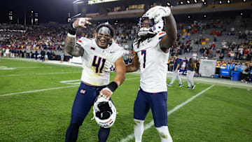 Nov 28, 2025; Tempe, Arizona, USA; Arizona Wildcats defensive lineman Julian Savaiinaea (41) and linebacker Chase Kennedy (7) celebrate after defeating the Arizona State Sun Devils during the 99th Territorial Cup at Mountain America Stadium. Mandatory Credit: Mark J. Rebilas-Imagn Images