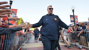 Sep 27, 2025; Champaign, Illinois, USA;  Illinois Fighting Illini head coach Bret Bielema leads his team down the Illini Walk before an NCAA football game with the Southern California Trojans at Memorial Stadium. Mandatory Credit: Ron Johnson-Imagn Images