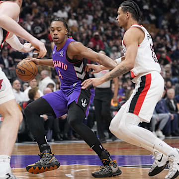 Apr 3, 2025; Toronto, Ontario, CAN; Toronto Raptors guard Scottie Barnes (4) is surrounded by Portland Trail Blazers center Donovan Clingan (23) and forward Toumani Camara (33) during the first half at Scotiabank Arena. Mandatory Credit: John E. Sokolowski-Imagn Images