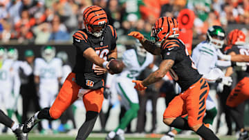 Oct 26, 2025; Cincinnati, Ohio, USA; Cincinnati Bengals quarterback Joe Flacco (16) passes the ball to running back Chase Brown (30) during the first quarter at Paycor Stadium. Mandatory Credit: Katie Stratman-Imagn Images