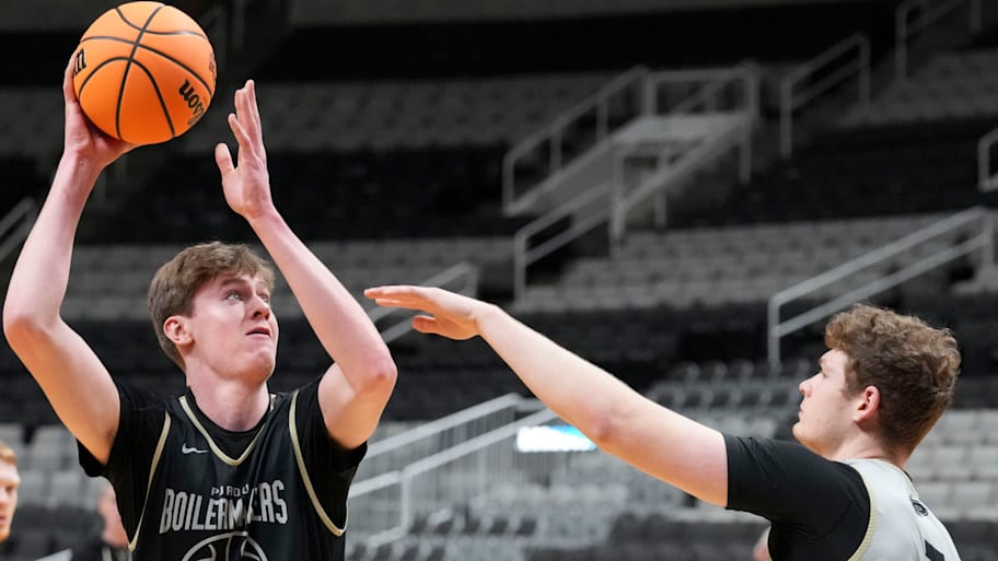 Purdue Boilermakers center Daniel Jacobsen shoots the ball over forward Sam King during practice.