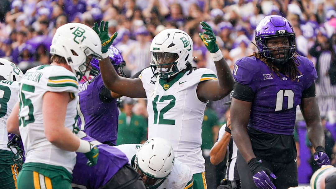 Oct 18, 2025; Fort Worth, Texas, USA; Baylor Bears tight end Kelsey Johnson (12) reacts after a touchdown run by  running back Bryson Washington against the TCU Horned Frogs during the first half of a game at Amon G. Carter Stadium. Mandatory Credit: Raymond Carlin III-Imagn Images