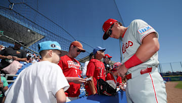 Philadelphia Phillies infielder Aidan Miller (81) signs autographs for fans before a game against the Toronto Blue Jays during spring training at TD Ballpark on March 2.