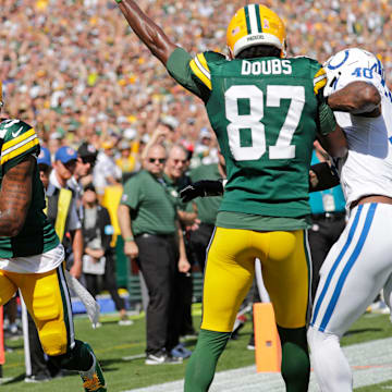 Green Bay Packers wide receiver Dontayvion Wicks (13) scores a touchdown against the Colts, thanks in part to a block by Romeo Doubs.