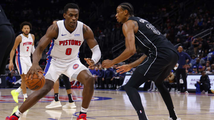 Mar 7, 2024; Detroit, Michigan, USA;  Detroit Pistons center Jalen Duren (0) dribbles defended by Brooklyn Nets center Nic Claxton (33) in the first half at Little Caesars Arena. Mandatory Credit: Rick Osentoski-USA TODAY Sports