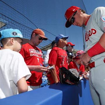 Mar 2, 2025; Dunedin, Florida, USA; Philadelphia Phillies infielder Aidan Miller (81) signs autographs for fans before a game against the Toronto Blue Jays during spring training at TD Ballpark. 