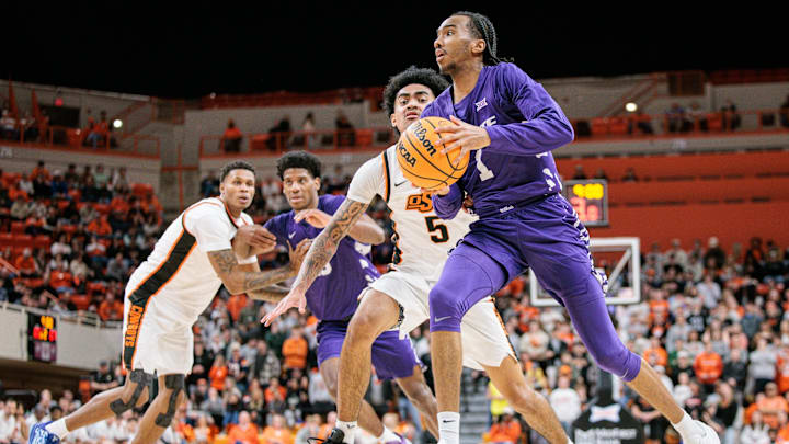 Jan 17, 2026; Stillwater, Oklahoma, USA; Abdi Bashir Jr. (1) of the Kansas State Wildcats drives to the basket around Vyctorius Miller (5) of the Oklahoma State Cowboys during the second half at Gallagher-Iba Arena. 