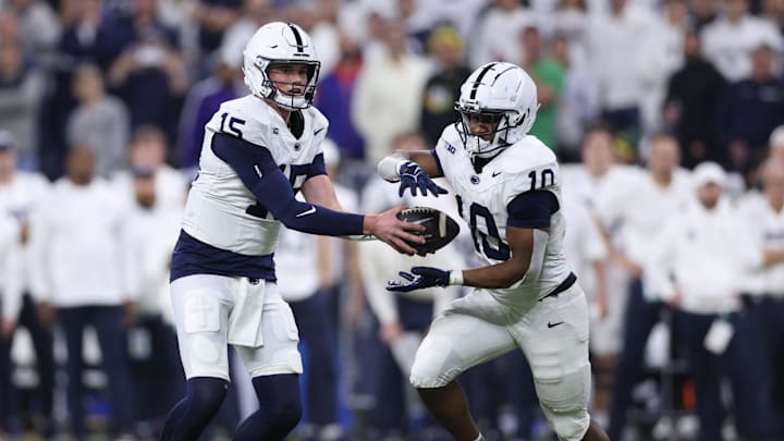 Penn State Nittany Lions quarterback Drew Allar (15) hands off to running back Nicholas Singleton (10) 