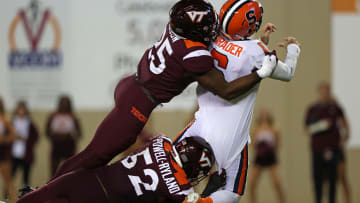 Oct 26, 2023; Blacksburg, Virginia, USA; Virginia Tech Hokies defensive linemanCole Nelson and defensive lineman Antwaun Powell-Ryland (52) sack Syracuse Orange quarterback Garrett Shrader (6) in the end zone for a safety during the third quarter at Lane Stadium. Mandatory Credit: Peter Casey-USA TODAY Sports